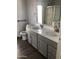 Bathroom featuring a double sink vanity with modern faucets and stone countertops at 9632 W Runion Dr, Peoria, AZ 85382