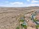 Drone shot of the neighborhood featuring the desert landscape, backyard pools and mountain views at 9686 W Keyser Dr, Peoria, AZ 85383