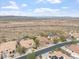 An aerial shot of houses in a neighborhood with desert landscaping and mountain views beyond the desert landscape at 9686 W Keyser Dr, Peoria, AZ 85383