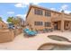 An outdoor kitchen with a built-in BBQ, a hot tub, and ample seating for entertainment at 9686 W Keyser Dr, Peoria, AZ 85383