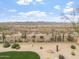 View of the backyard featuring a desert landscape, pool, patio, grassy area and mountain views beyond the fence at 9686 W Keyser Dr, Peoria, AZ 85383