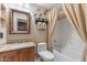 Bathroom features a vanity with granite countertop, tiled shower with curtain, and stone wall design at 9686 W Keyser Dr, Peoria, AZ 85383