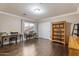 Spacious room with hardwood floors featuring two workstations and a built-in shelving unit at 9686 W Keyser Dr, Peoria, AZ 85383