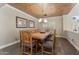 Elegant dining room with a large wooden table, rustic chairs, and decorative ceiling, ideal for Gathering gatherings at 9686 W Keyser Dr, Peoria, AZ 85383