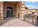 Elegant home entrance featuring arched columns and wrought iron at 9686 W Keyser Dr, Peoria, AZ 85383