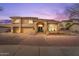 Inviting two-story home with manicured landscaping, arched entryway, and brick driveway, offering elegant curb appeal at 9686 W Keyser Dr, Peoria, AZ 85383