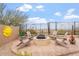 Charming backyard fire pit area with comfortable Adirondack seating and a scenic desert view at 9686 W Keyser Dr, Peoria, AZ 85383