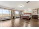 Well-lit main bedroom featuring expansive windows, hardwood floors, and ample space at 9686 W Keyser Dr, Peoria, AZ 85383