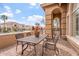 Outdoor seating area featuring a wrought iron table and chairs with a beautiful home in the background at 9686 W Keyser Dr, Peoria, AZ 85383