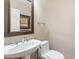 Stylish powder room featuring a pedestal sink with elegant fixtures and decorative mirror at 9686 W Keyser Dr, Peoria, AZ 85383