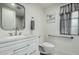 Modern bathroom featuring a white vanity with solid surface top and gray accents at 9918 W Willow Creek Cir, Sun City, AZ 85373