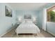 Serene bedroom featuring soft blue walls, hardwood floors, and a cozy bed with two side tables and artwork at 9918 W Willow Creek Cir, Sun City, AZ 85373