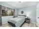 Comfortable bedroom with light blue walls and a window overlooking the yard at 9918 W Willow Creek Cir, Sun City, AZ 85373