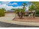 Charming single-story home with desert landscaping, palm trees, and solar panels at 9918 W Willow Creek Cir, Sun City, AZ 85373