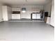 Spacious garage features a laundry area, refrigerator, cabinets and shelving for ample storage options at 9918 W Willow Creek Cir, Sun City, AZ 85373