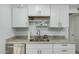 Bright kitchen with white cabinets, stainless steel appliances, granite countertops and plenty of natural light at 9918 W Willow Creek Cir, Sun City, AZ 85373