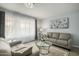 Bright living room featuring neutral tones, updated flooring, and large windows with views at 9918 W Willow Creek Cir, Sun City, AZ 85373