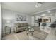 Bright living room featuring neutral tones, updated flooring, and open floorplan to kitchen at 9918 W Willow Creek Cir, Sun City, AZ 85373