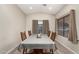 Cozy dining room with modern wood floors and a full table set at 9948 N 94Th Ave, Peoria, AZ 85345