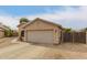 Charming single-story home with a two-car garage, sidewalk and desert landscaping at 9948 N 94Th Ave, Peoria, AZ 85345