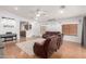 Inviting living room featuring hardwood floors, a ceiling fan, and comfortable leather furniture at 9948 N 94Th Ave, Peoria, AZ 85345