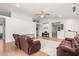 Spacious living room with bright white walls, a ceiling fan, and hardwood floors at 9948 N 94Th Ave, Peoria, AZ 85345