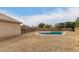 Backyard pool with surrounding desert landscaping, enclosed by a fence for enhanced privacy at 9948 N 94Th Ave, Peoria, AZ 85345