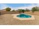 Geometric backyard pool surrounded by desert landscaping and block wall, perfect for relaxing and entertaining at 9948 N 94Th Ave, Peoria, AZ 85345