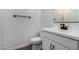 Well-lit bathroom featuring a white vanity with dark fixtures and minimalist design at 11605 W Green Dr, Youngtown, AZ 85363
