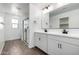 Modern bathroom featuring double sink vanity, large mirror, and glass shower at 11605 W Green Dr, Youngtown, AZ 85363