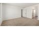 Bright bedroom with neutral carpet, white walls, and natural light at 11605 W Green Dr, Youngtown, AZ 85363