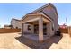 View of the exterior and covered patio of a tan two-story home at 11605 W Green Dr, Youngtown, AZ 85363