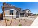 Exterior view of a two story home with desert landscaping and a two car garage at 11605 W Green Dr, Youngtown, AZ 85363