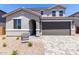 Charming two-story home featuring a neutral color palette, an attached two-car garage, and low maintenance desert landscaping at 11605 W Green Dr, Youngtown, AZ 85363