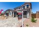 Two-story home featuring a private two-car garage, desert landscaping, and a private entry at 11605 W Green Dr, Youngtown, AZ 85363