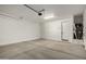 Spacious two-car garage with concrete floor and automatic door opener system at 11605 W Green Dr, Youngtown, AZ 85363