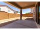 Covered patio with concrete flooring overlooking the backyard with block wall at 11605 W Green Dr, Youngtown, AZ 85363