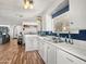 Well-lit kitchen features white cabinets, modern appliances, a stainless steel sink, and blue accented walls at 120 N Val Vista Dr # 178, Mesa, AZ 85213