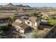 An aerial view of the home shows solar panels, lush landscaping, and an inviting neighborhood at 13346 W Jesse Red Dr, Peoria, AZ 85383