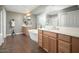 Bright bathroom with double vanities, a soaking tub, and wood-look flooring at 13346 W Jesse Red Dr, Peoria, AZ 85383