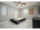 Empty bedroom with a platform bed frame, ceiling fan, and neutral gray walls at 13346 W Jesse Red Dr, Peoria, AZ 85383