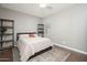 Bedroom featuring a queen bed, wooden floors, shelves, and an area rug at 13346 W Jesse Red Dr, Peoria, AZ 85383