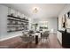 Bright dining room featuring modern shelving, a hardwood floor, and elegant chandelier lighting at 13346 W Jesse Red Dr, Peoria, AZ 85383