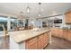 Spacious eat-in kitchen with center island, granite countertops, and pendant lighting at 13346 W Jesse Red Dr, Peoria, AZ 85383