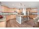 Bright kitchen features stainless steel appliances, spacious island with seating and ample cabinet space at 13346 W Jesse Red Dr, Peoria, AZ 85383