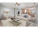 Open living space features hardwood floors, a ceiling fan and a seamless transition to the kitchen at 13346 W Jesse Red Dr, Peoria, AZ 85383