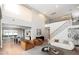 Open-concept living area boasts hardwood floors, contemporary furnishings, and seamless dining room access at 13346 W Jesse Red Dr, Peoria, AZ 85383