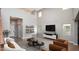 Bright living room boasts soaring ceilings, modern shelving, and stylish contemporary furnishings at 13346 W Jesse Red Dr, Peoria, AZ 85383