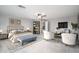 Spacious main bedroom features a ceiling fan, shelving, and luxurious upholstered bed at 13346 W Jesse Red Dr, Peoria, AZ 85383