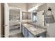 Double sink bathroom featuring granite countertops, tile floors, and a view of the main bedroom at 15380 N 100Th St # 2098, Scottsdale, AZ 85260